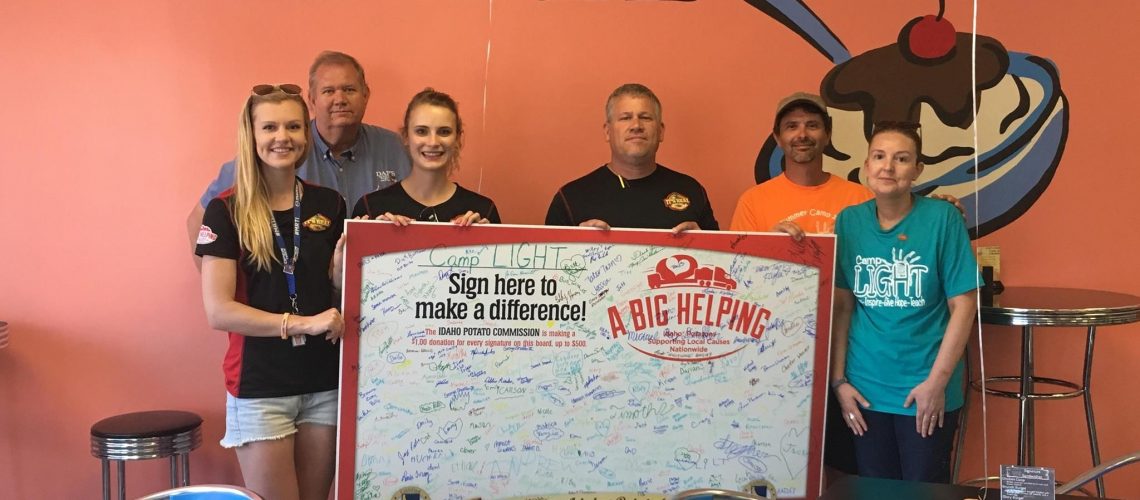 The Signature Board for Camp LIGHT! Left to Right: Kaylee, Phil from DAP's, Jessica, Larry, and Scott & Cathy from Camp LIGHT.